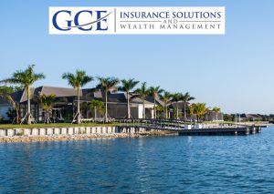 A beautiful waterfront home on a gorgeous blue-sky day with palm trees in the backyard.